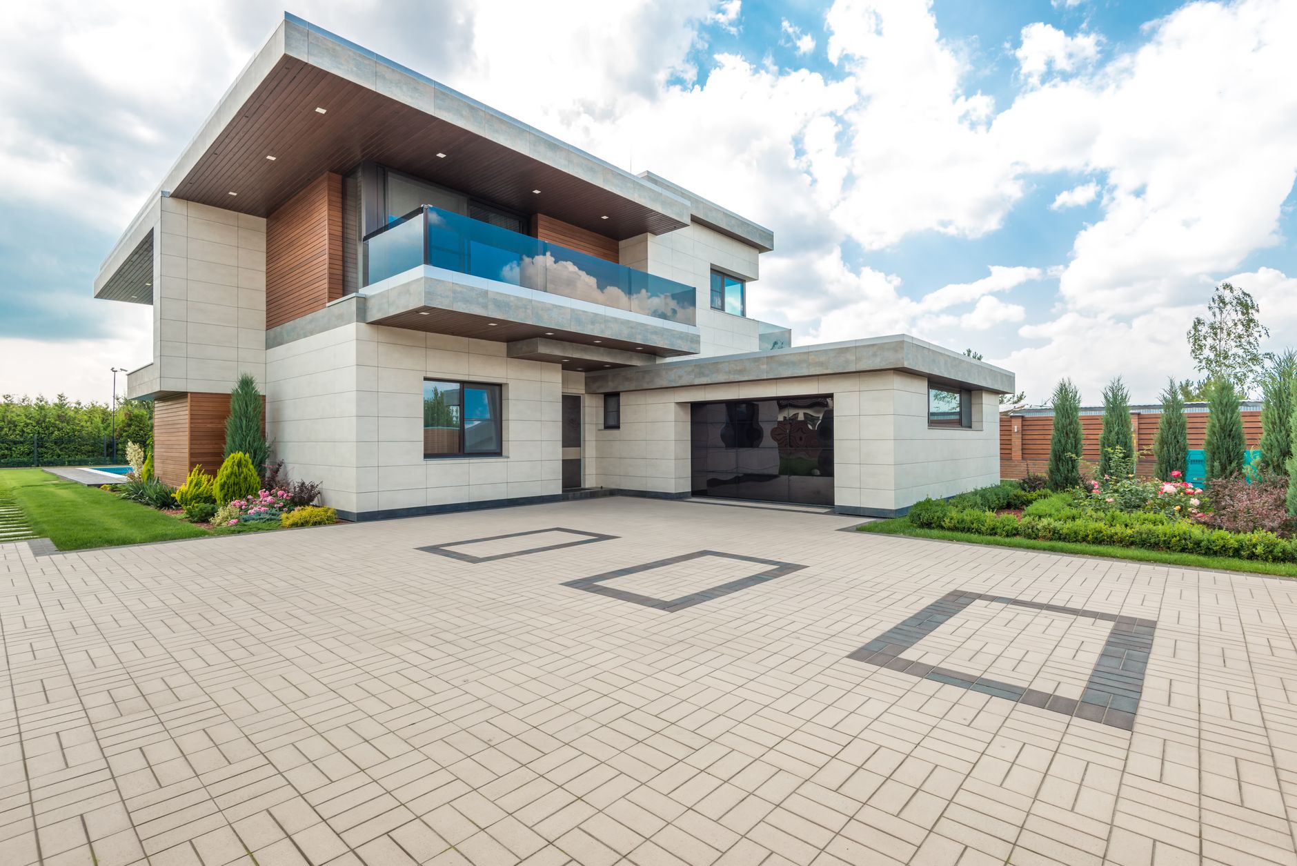 Elegant home with concrete driveway and landscaping